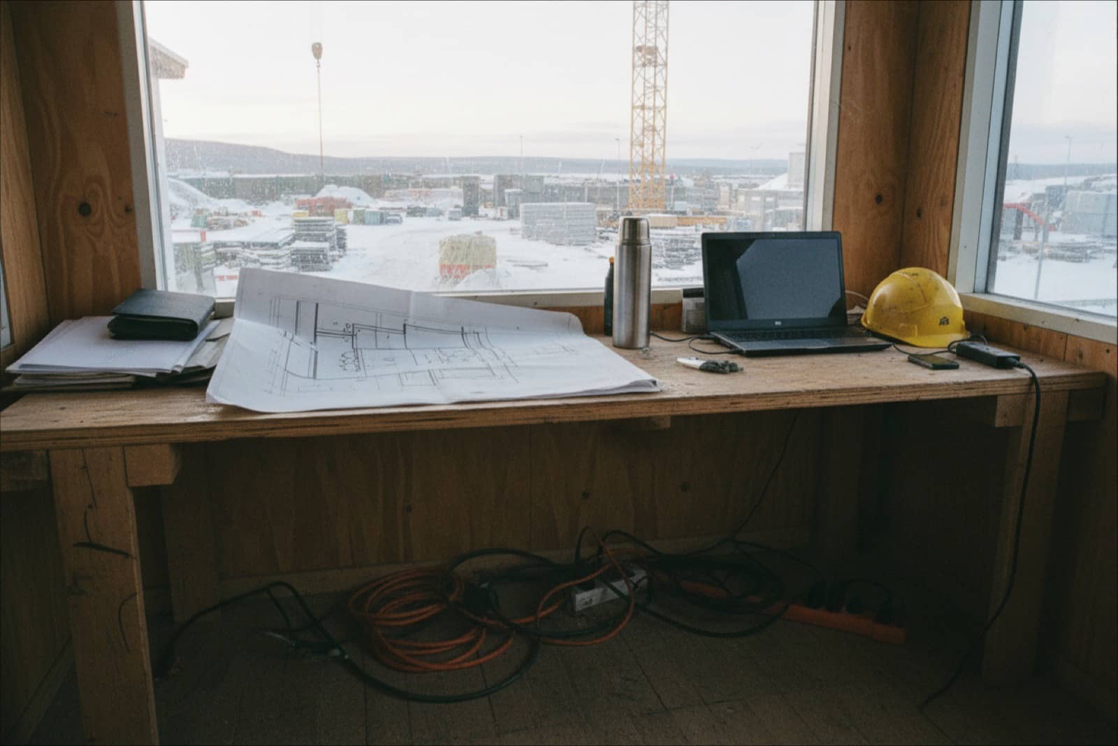 Site office desk with drawings and a helmet on a Norwegian building site